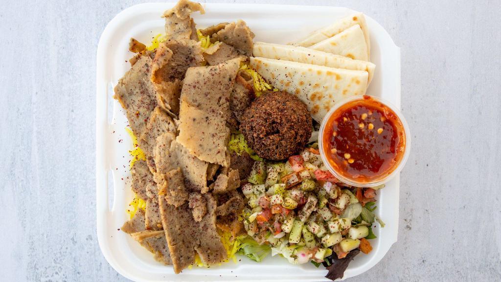 Mixed Lamb & Beef Gyro Platter · Includes yellow rice, pita bread, one falafel, salad, tahini sauce, and our signature garlic sauce.