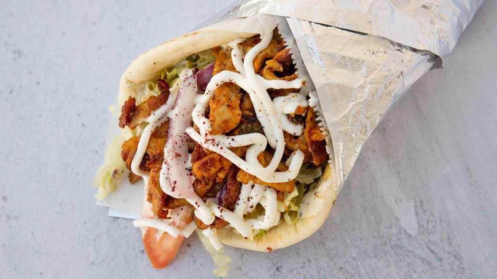 Chicken Shawarma Sandwich · Includes crispy lettuce, fresh tomatoes, onions, tahini sauce, and our signature garlic sauce.