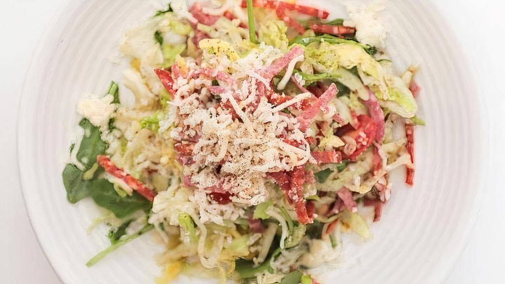 Chopped Salad · Tricolor greens, salami, fontina cheese, garbanzos, cherry tomatoes, pepperoncini, oregano vinaigrette.