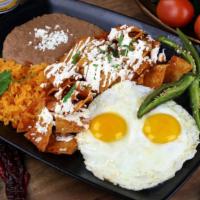 Chilaquiles Clásicos · A traditional Mexican breakfast! Topped with queso fresco cheese, cream, onion and cilantro....