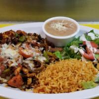 El Capricho · Chicken, beef, shrimp, chorizo, bacon, bell pepper, onions and cheese. Includes rice, beans ...
