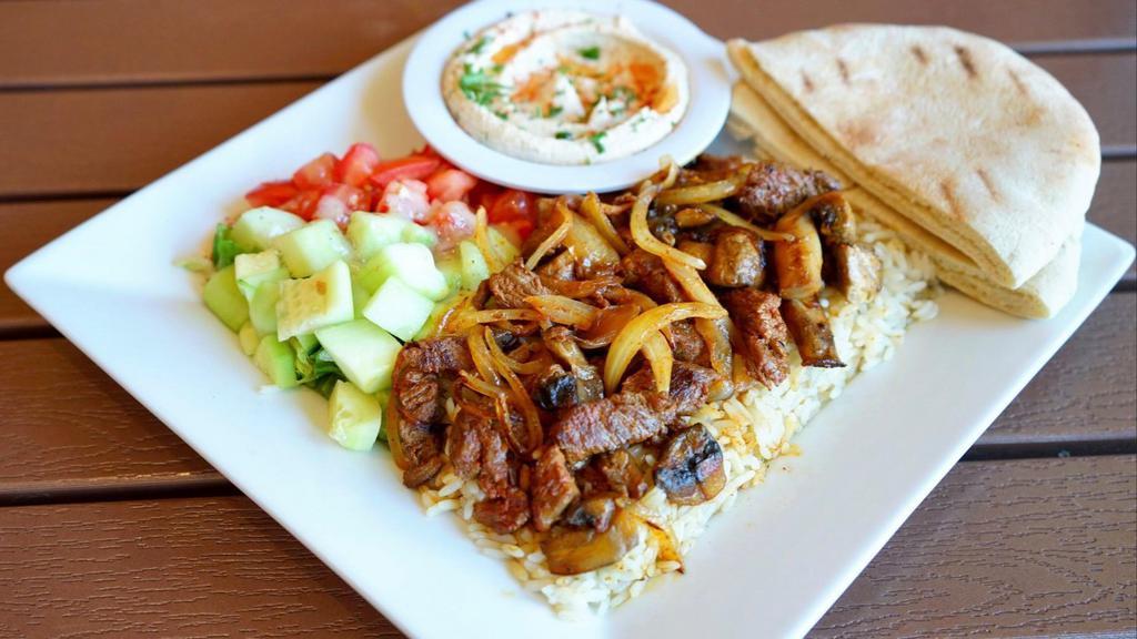 Steak Kabob Plate · Tender pieces of marinated steak with grilled onions and mushrooms, served with hummus, pita bread, salad, and rice, brown rice or fries.