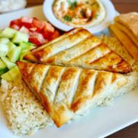 Spinach Pie (Spanakopita) · Two pies baked upon order. Served with salad, hummus, pita bread, and your choice of rice, b...