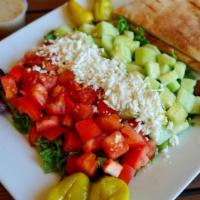 Greek Salad · Greek salad topped with feta cheese, olives, and pepperoncinis with our house dressing on th...