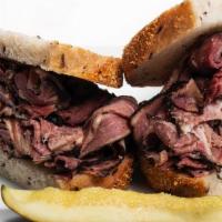 Hot Corned Beef/ Pastrami · Piled high on rye bread and served with a kosher dill pickle spear.