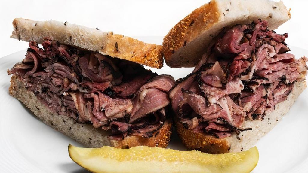 Hot Corned Beef/ Pastrami · Piled high on rye bread and served with a kosher dill pickle spear.