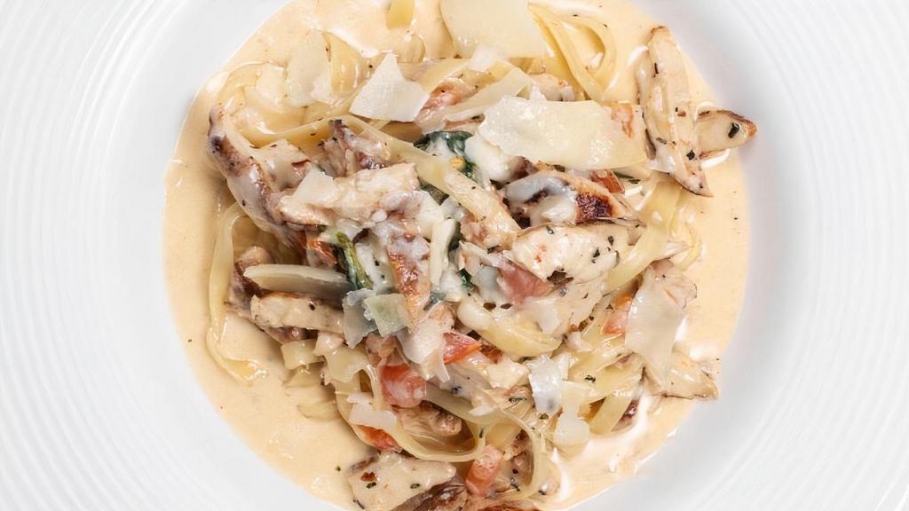 Fettuccine Pollo Champagne · Chicken breast sautéed in olive oil, fresh basil, tomatoes, garlic & our light champagne sauce, topped with parmesan cheese.