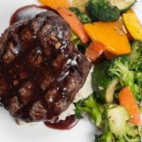 Filet Mignon · Angus filet mignon served over mashed potatoes, seasonal vegetables with Chef’s special redu...