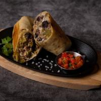 Carnitas Burrito · Carnitas burrito, crisped on the flat top with rice, beans, pico de gallo, and salsa.