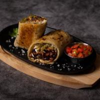 Chorizo Burrito · Chorizo burrito, crisped on the flat top with rice, beans, pico de gallo, and salsa.