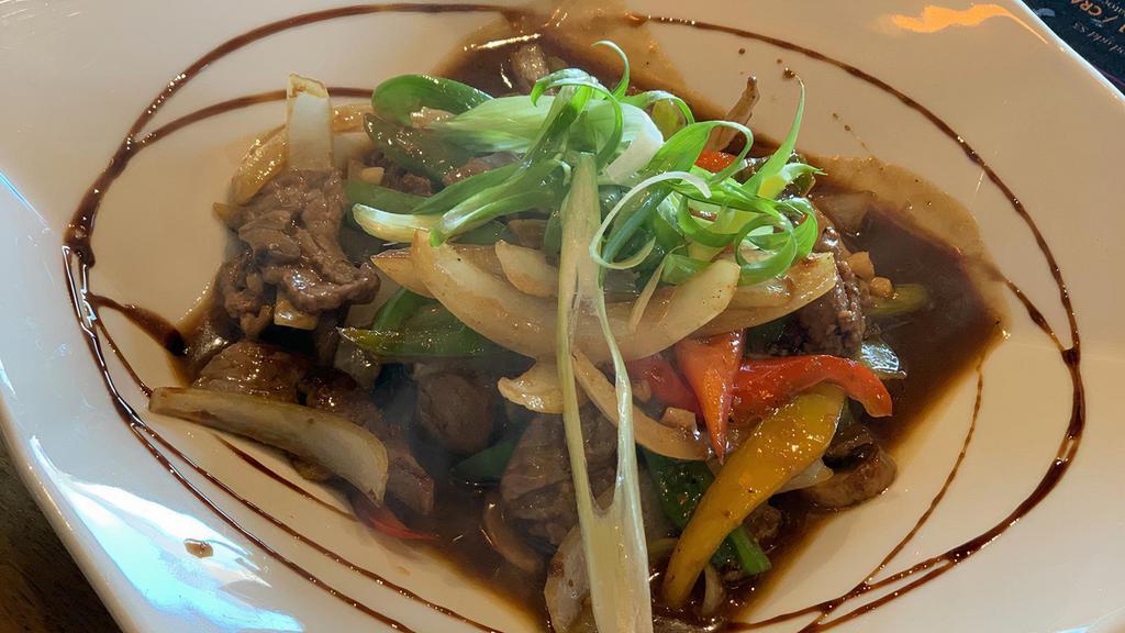 Mongolian Beef · Stir-fried beef with onion, carrot, and bell pepper in gravy sauce.