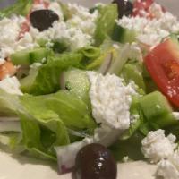 Greek Salad · Romaine, roma tomatoes, Greek olives, red onions, feta, cucumbers and a creamy house vinaigr...
