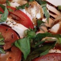 Caprese Salad · Roma tomatoes, fresh mozzarella, fresh basil and balsamic reduction.