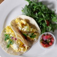 Breakfast Tacos · Two scrambled eggs, house made avocado blend, on two corn tortilla. Garnished with fresh cil...