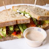 Veggie Sandwich · Toasted country bread, avocado, roasted bell peppers, hummus, tomatoes, red onions, carrots,...