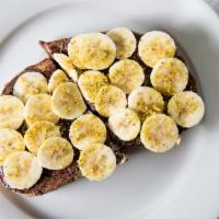 Nutella Banana Toast · Nutella and banana on country toast garnished with pistachios.