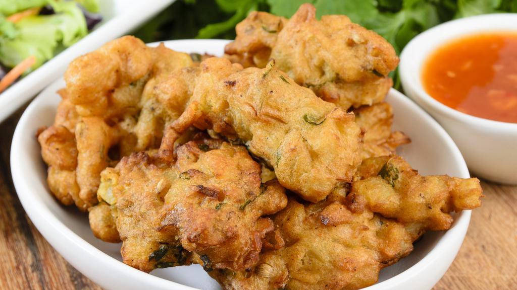 Mixed Pakora · Traditionally prepared assortment of fried vegetable fritters including fresh ingredients such as cauliflower, onions, potatoes and spinach.