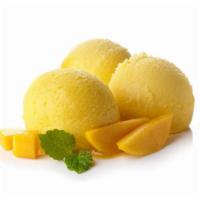 Mango Ice Cream · Delicious ice cream made with mango pulp and green cardamom seeds.