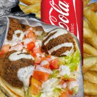 Falafel Sandwich Combo · Four falafel balls with lettuce, tomatoes, and grilled pita bread with French Fries & Soda o...