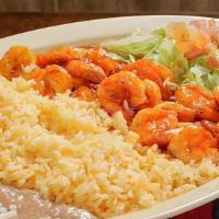 Camarones A La Diabla · Shrimp in red chilli sauce. Served with rice, beans, salad, and tortillas.