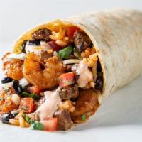 Surf & Turf Burrito · Marinated steak, shrimp, black beans, Spanish rice, lime, cheese, Baja sauce &  a choice of ...