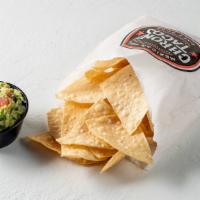 Chips And Guacamole · Bag of house fried corn tortilla chips. served with a side of fresh guacamole