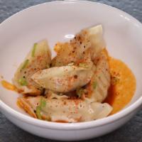 Spicy Gyoza · Steamed pot stickers with spicy sauce.