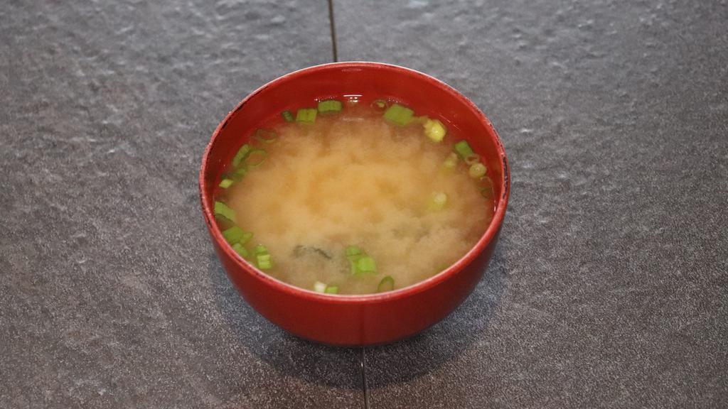 Miso Soup · A traditional Japanese miso soup served with tofu, green onions, and wakame (seaweed).
