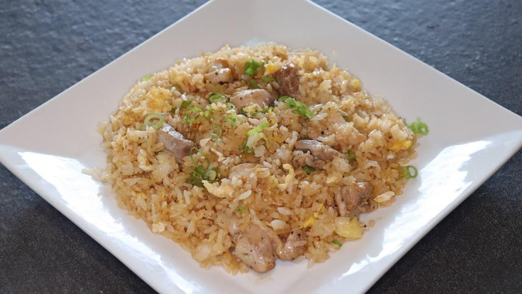 Chicken Fried Rice · Pan-fried rice, chicken, and egg topped with green onions and sesame seeds.