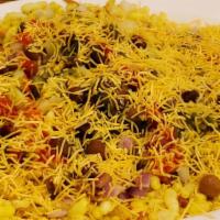 Bhel Puri (Vegan) · Mixed puffed rice and fried chips with sweet, savory chutneys, onions, sev, cilantro, and sw...