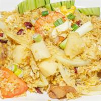 Pineapple Fried Rice · Fried rice with chicken, shrimp, curry powder, pineapple, cashew nut, raisin and egg.