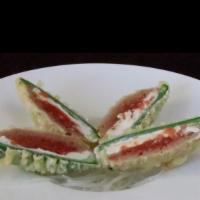 Jalapeno Bomb · Stuffed jalapenos with spicy tuna and cream cheese (4 pieces). Deep-fried and finished with ...