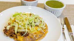 Shredded  Beef Tostada · Meat, beans, lettuce and cheese
