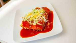 Shredded Beef · two a la carte enchiladas with cheese on top, sour cream, guacamole and lettuce on the side
