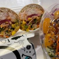 Sushi Rrito · Seaweed or soy wrap, sushi rice two scoops of protein four toppings and one crunch.