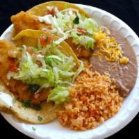 #13 2 Fish Tacos · Two fish tacos topped with pico, cabbage and tartar sauce. Served with rice and beans.