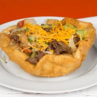 Beef Taco Salad · Shredded beef sautéed with onion, bell pepper and tomatoes,  beans, lettuce, guacamole, sour...