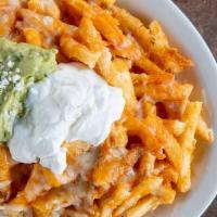 Nacho Fries · French fries with melted Jack cheese and ranchera sauce. Topped with guacamole and sour crea...