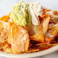 Nachos · Fresh corn tortilla chips, refried beans, Jack cheese, and ranchera sauce. Topped with guaca...