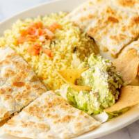 Quesadilla Poblano · Large flour tortilla with cheese, poblano chiles, onions, and corn. Served with rice and gua...