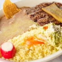 Platillo De Bistec Encebollado · Chopped steak and grilled onions served with rice, refried beans, guacamole, and tortillas.