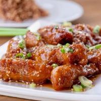 Orange Chicken · Deep-fried chicken glazed with orange sauce. Topped with scallion and sesame seeds. Served w...