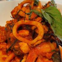 Seafood Pasta · Salmon, shrimp, calamari tossed with roasted garlic, fresh basil, and pomodoro sauce, tossed...
