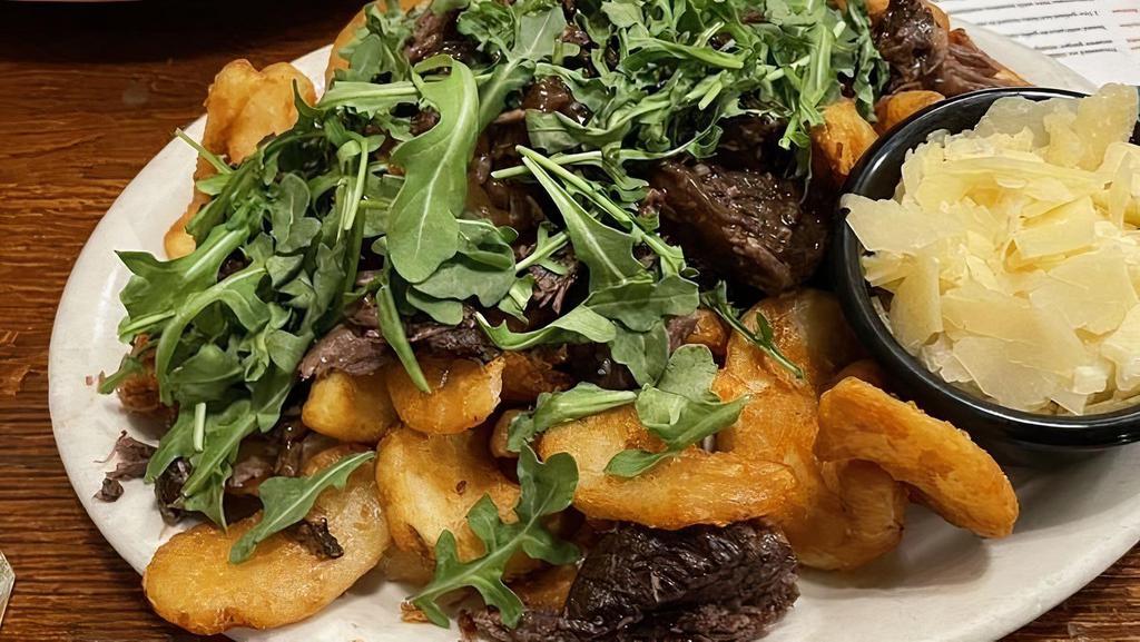 Short Rib Fries · Sidewinder fries with boneless marinated short ribs with truffle oil, shaved Parmesan, and arugula.