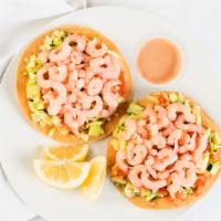 Shrimp Tostada · Shrimp tostada served with house sauce topped with fresh cut cucumber, tomato, avocado and a...