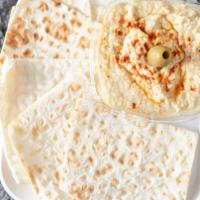 Hummus · Creamy blend of garbanzo beans, tahini, and fresh garlic drizzled with extra virgin olive oi...