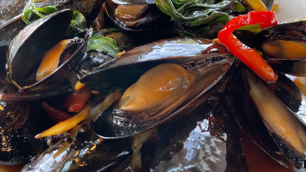 Thai Basil Ginger Blue Mussels · Blue mussels sautéed with Thai basil, green bell pepper, red bell pepper and white onion in a mild spicy ginger soy sauce.