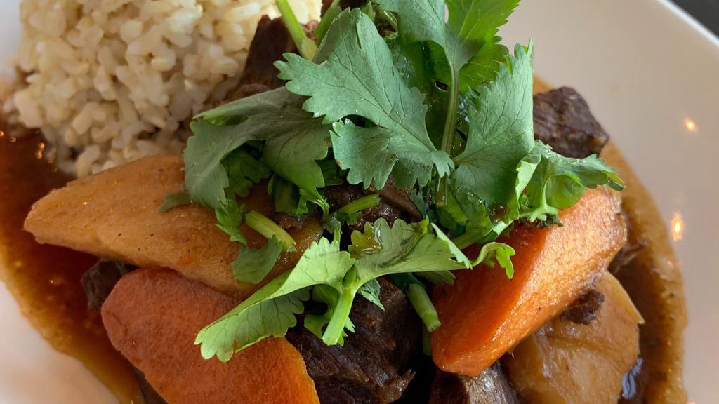 Braised Beef Pot Roast Plate · Tender slow-cooked beef in braising sauce with carrots and potatoes. with seasonal vegetables & steamed rice.
