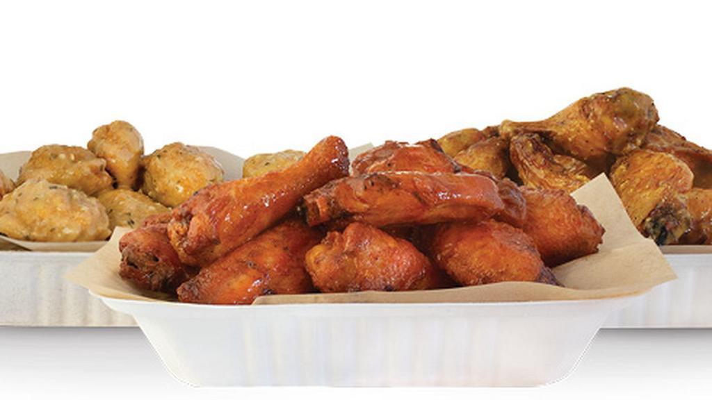 75 Pcs Party Pack · Choice of 75 crisp boneless wings, classic (bone-in), or a combination of boneless and bone-in wings with up to 5 flavors, 6 dips, 3 large hand cut fries, 3 veggie sticks. (Feeds 9-13)