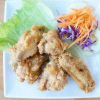 Crispy Wings · Fried chicken wings marinated with thai herbs served with sweet chili sauce.